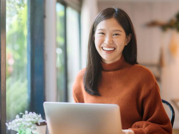 Woman sitting at desk with laptop 
