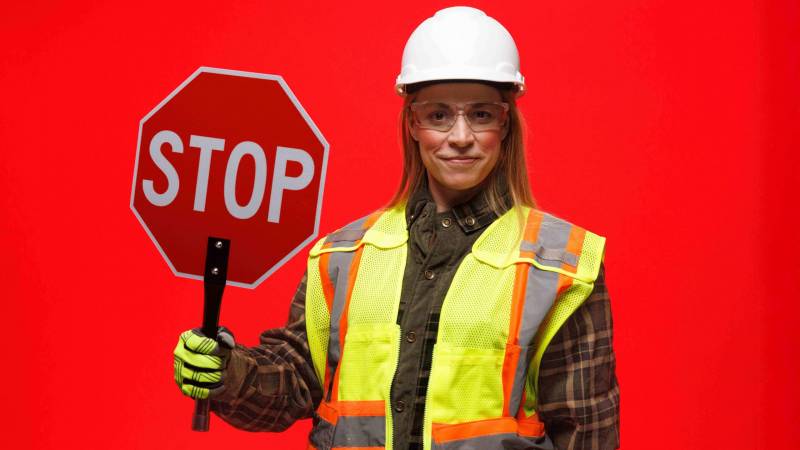 Woman holding stop sign