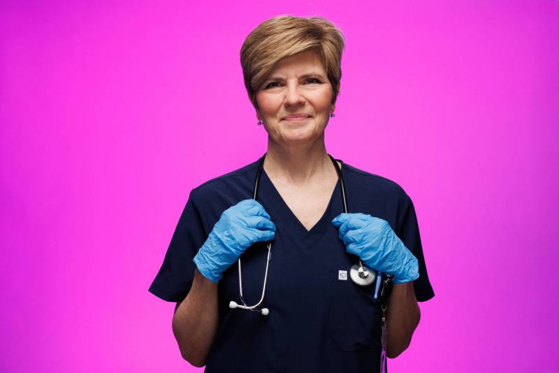 Woman resting hands on stethoscope